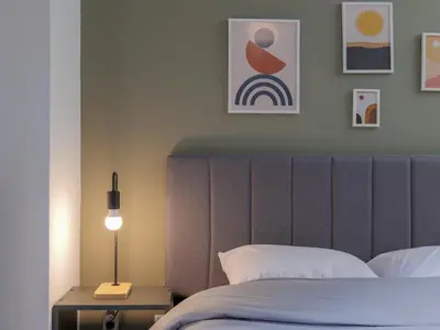 a bedroom with a bed with a headboard and a lamp at Alluring 2BR apartment in Thiseio in Athens