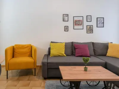 a living room with a couch and two chairs at Alluring 2BR apartment in Thiseio in Athens