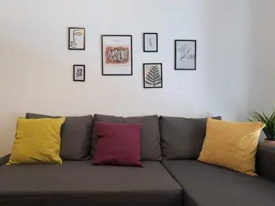 a gray couch with colorful pillows in a living room at Alluring 2BR apartment in Thiseio in Athens