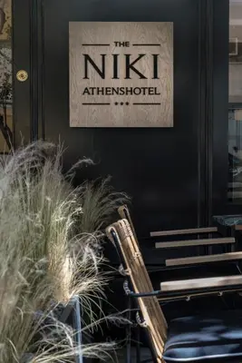a sign on the wall of a nitzitzitzitzitzitzitzitz at Niki Athens Hotel in Athens