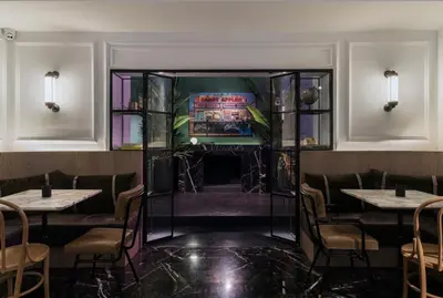 a dining room with tables and a fireplace at Niki Athens Hotel in Athens
