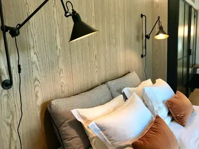 a room with two lamps and a couch with pillows at Niki Athens Hotel in Athens