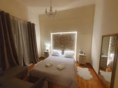 a bedroom with a bed and a large window at John's Athenian Beauty 45m2 , Metro 7' in Athens