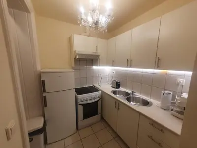 a kitchen with white cabinets and a sink and a refrigerator at John's Athenian Beauty 45m2 , Metro 7' in Athens