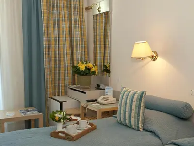 a living room with a bed and a table with cups on it at The Park Hotel Piraeus in Piraeus