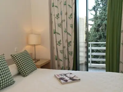 a bedroom with a bed and a window with a view at The Park Hotel Piraeus in Piraeus