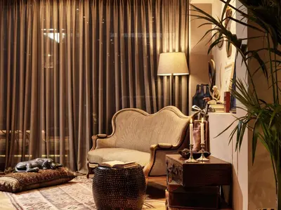 a living room with a chair in front of a window at Sea View Cityscape Hotel in Athens