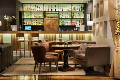 a restaurant with a table and chairs and a bar at Sea View Cityscape Hotel in Athens