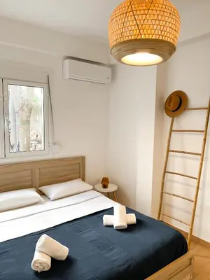 a bedroom with a bed with two towels on it at Comfy 2 BDR Apt in Petralona - Next to metro in Athens
