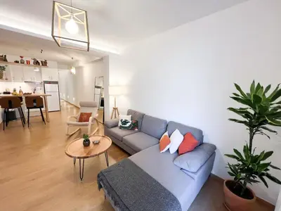 a living room with a blue couch and a table at Comfy 2 BDR Apt in Petralona - Next to metro in Athens