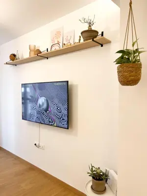 a living room with a tv on a wall at Comfy 2 BDR Apt in Petralona - Next to metro in Athens