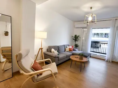a living room with a couch and a table at Comfy 2 BDR Apt in Petralona - Next to metro in Athens