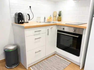 a small kitchen with white cabinets and a sink at Comfy 2 BDR Apt in Petralona - Next to metro in Athens