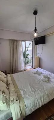 a large bed in a bedroom with a window at A peaceful apartment in Athens in Athens