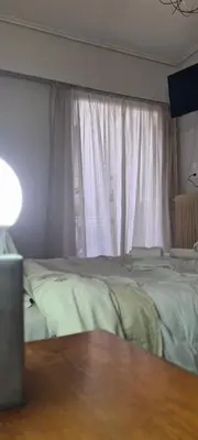 a bedroom with two beds and a window at A peaceful apartment in Athens in Athens