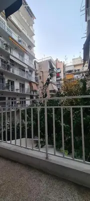 a white fence in front of some buildings at A peaceful apartment in Athens in Athens