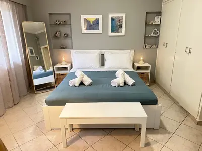 a bedroom with a bed with two pillows on it at Cozy apartment near the city center and beaches in Athens