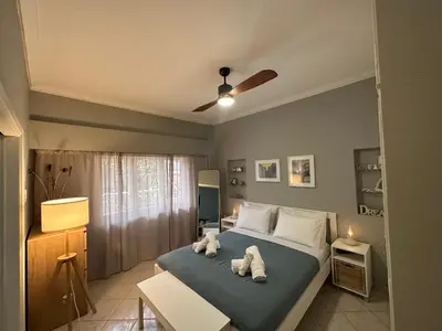 a bedroom with a bed with towels on it at Cozy apartment near the city center and beaches in Athens