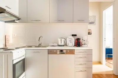a kitchen with white cabinets and a sink at New Huge 5BDR/2bath Apt(+netflix)/1min toAcropolis in Athens