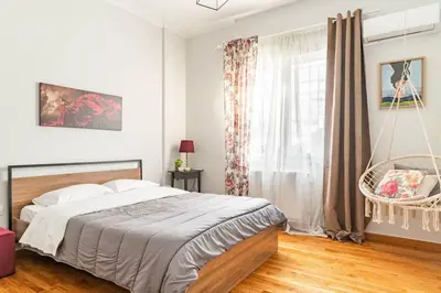 a bedroom with a bed and a swing at New Huge 5BDR/2bath Apt(+netflix)/1min toAcropolis in Athens