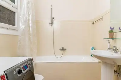 a bathroom with a shower and a toilet and a sink at New Huge 5BDR/2bath Apt(+netflix)/1min toAcropolis in Athens