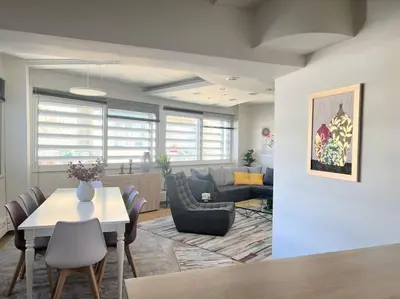 a living room with a table and a couch at HighEnd 5BDR NewApt w/Breathtaking Acropolis View in Athens