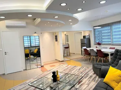 a living room with a couch and a table at HighEnd 5BDR NewApt w/Breathtaking Acropolis View in Athens