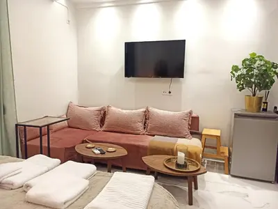 a living room with a couch and a flat screen tv at Mikalis Studio in Athens