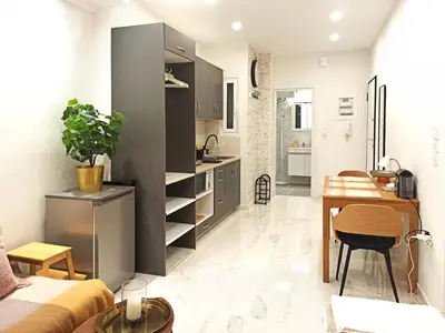 a small apartment with a kitchen and a dining room at Mikalis Studio in Athens