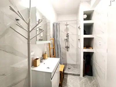 a bathroom with a shower and a white sink at Mikalis Studio in Athens