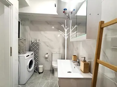 a white bathroom with a sink and a toilet at Mikalis Studio in Athens