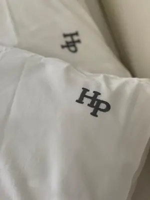 a white pillow with the hp logo on it at Platon Hotel in Piraeus