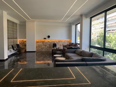 a living room with two couches and a table at Platon Hotel in Piraeus