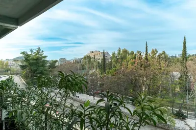 a view of a park with trees and buildings at Panoramic 1BR Apartment near Kallimarmaro Stadium by UPSTREET in Athens