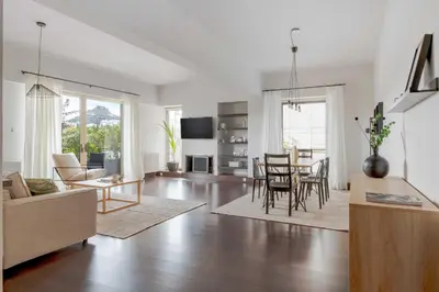 a living room with a couch and a table at Panoramic 1BR Apartment near Kallimarmaro Stadium by UPSTREET in Athens