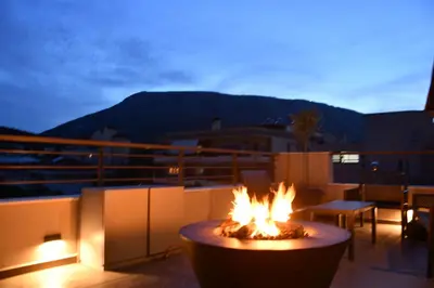 a fire pit on a balcony with a view at Spacious & Minimal Apartment Near Airport Peania Coniann Filoxenia in Paianía