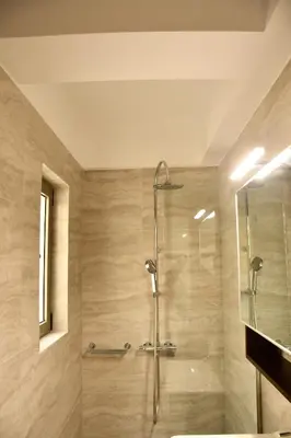 a bathroom with a shower with a glass door at Spacious & Minimal Apartment Near Airport Peania Coniann Filoxenia in Paianía