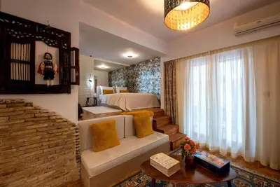 a bedroom with a bed and a couch and a table at Avant-Garde Studio in Athens
