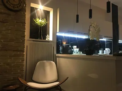 a white chair sitting at a counter in a kitchen at Avant-Garde Studio in Athens