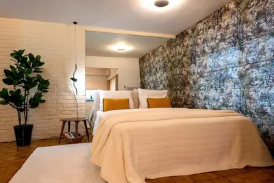a bedroom with a large bed with a large wall at Avant-Garde Studio in Athens