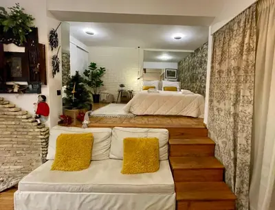 a large bedroom with two beds and a couch at Avant-Garde Studio in Athens