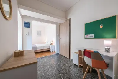 a small room with a desk and a bed at Athens F&K Aphrodite Apartment in Athens
