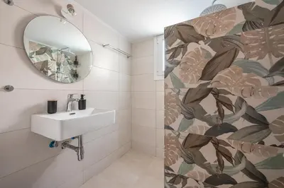 a bathroom with a sink and a mirror at Athens F&K Aphrodite Apartment in Athens
