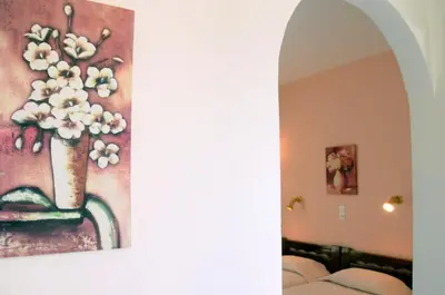 a painting of a vase with white flowers in it at Senia Studios in Agia Marina Aegina