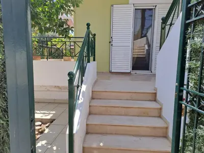 a set of stairs leading to the door of a house at Dimitris place near Athens airport in Koropíon