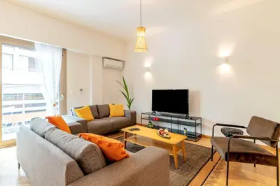 a living room with a couch and a tv at Boutique07 Luxury Apartment, Athens, Acropolis. in Athens