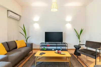 a living room with a couch and a tv at Boutique07 Luxury Apartment, Athens, Acropolis. in Athens