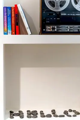 a white table with a book shelf with a radio and books at Boutique07 Luxury Apartment, Athens, Acropolis. in Athens