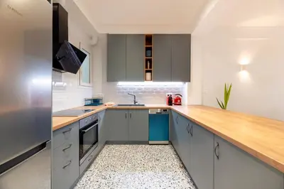 a kitchen with gray cabinets and a wooden counter top at Boutique07 Luxury Apartment, Athens, Acropolis. in Athens