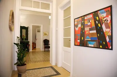 a hallway with a painting hanging on a wall at Aroura Neoclassical Home 3BR 2BA in Athens